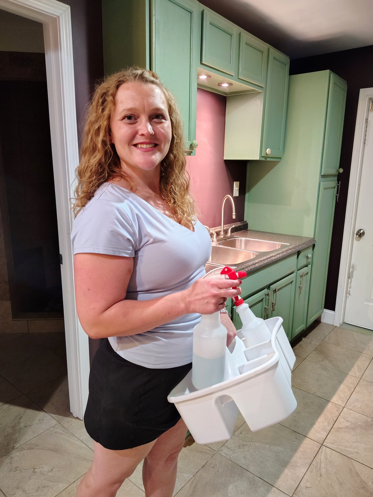Jessica with cleaning supplies in a kitchen for Dyersburg Cleaning
